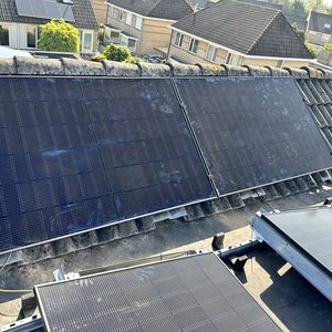 Deze afbeelding toont zonnepanelen op het dak van een woning, gericht op het genereren van zonne-energie.