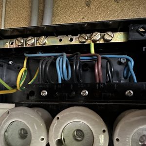 De afbeelding toont een meterkast met bedrading en aansluitingen voor elektrische systemen in een zonnepaneleninstallatie.